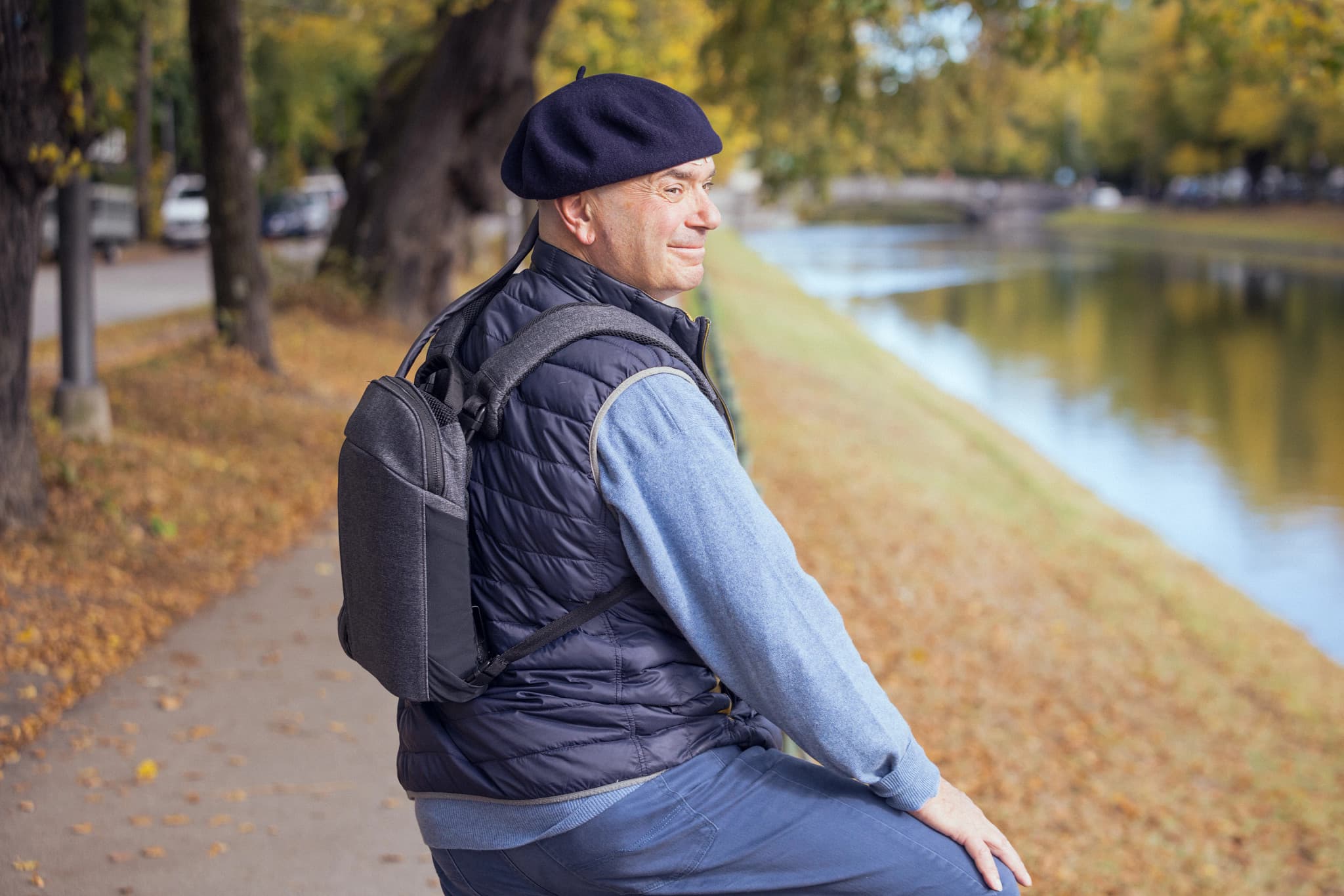 Smiling healthcare professional in a white lab coat holding a tablet indoors